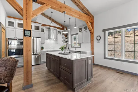 a kitchen with stainless steel appliances granite countertop a stove and a refrigerator