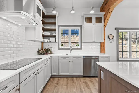 a kitchen with a sink stove and cabinets