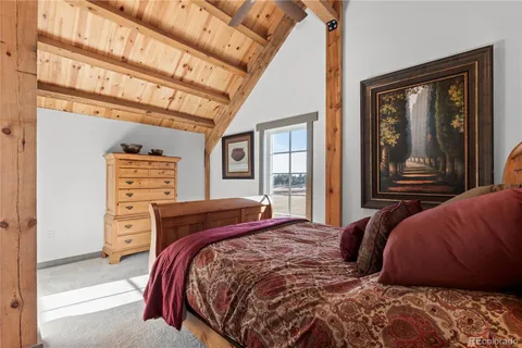 a bedroom with a bed next to a window