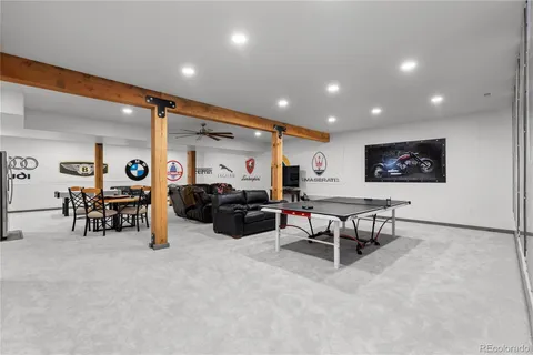 a living room with furniture a table and a flat screen tv