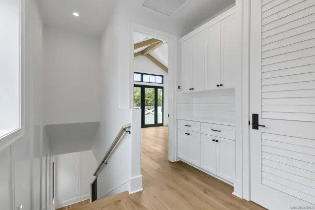 a view of an entryway with wooden floor