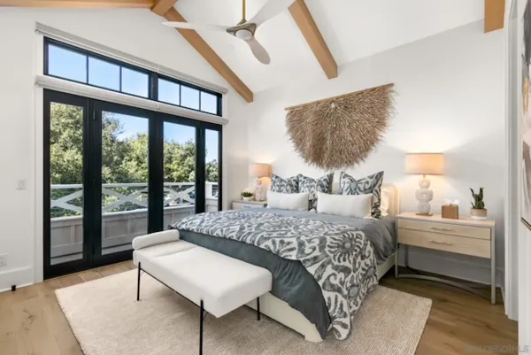 a bedroom with a bed and a large window