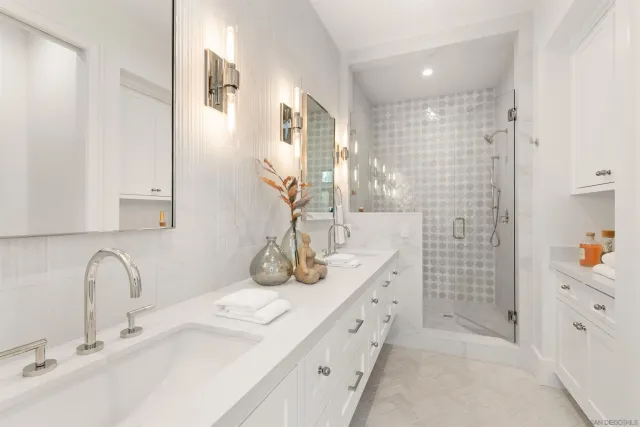 a bathroom with a double vanity sink mirror and shower