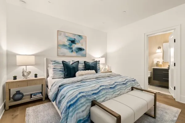 a bedroom with a bed and a lamp