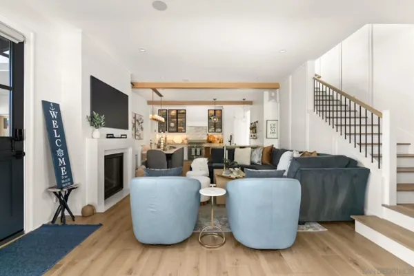 a living room with furniture a flat screen tv and a fireplace