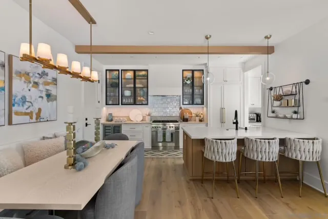 a living room with furniture a chandelier and a dining table