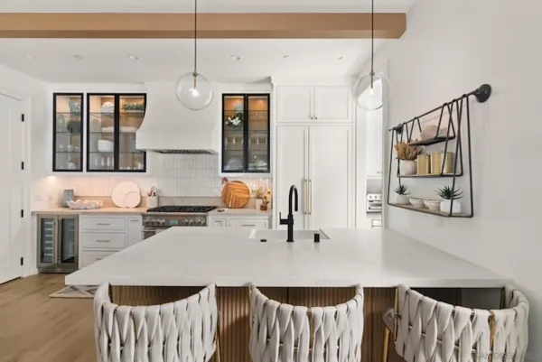 a kitchen with a sink a stove a dining table and chairs