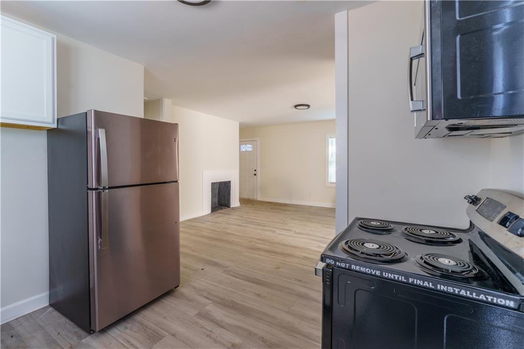 1365 Campbellton Road Southwest Atlanta, GA 30310 - Photo 17 of 36 a kitchen with a refrigerator and a stove top oven