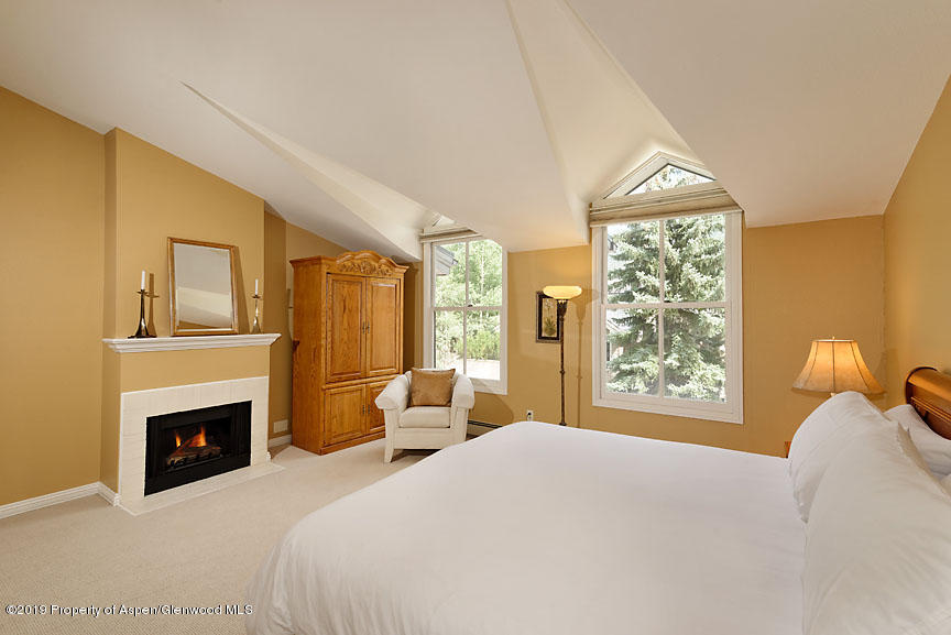 814 East Cooper Avenue Aspen, CO 81611 - Photo 11 of 15 a bedroom with a bed and a fireplace