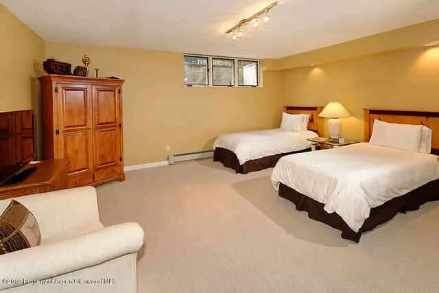 a bedroom with two beds and painted walls