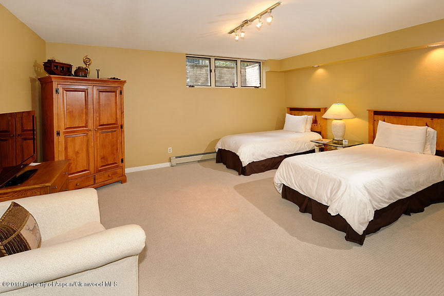 814 East Cooper Avenue Aspen, CO 81611 - Photo 12 of 15 a bedroom with two beds and painted walls