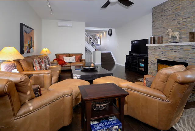 a living room with furniture and a fireplace
