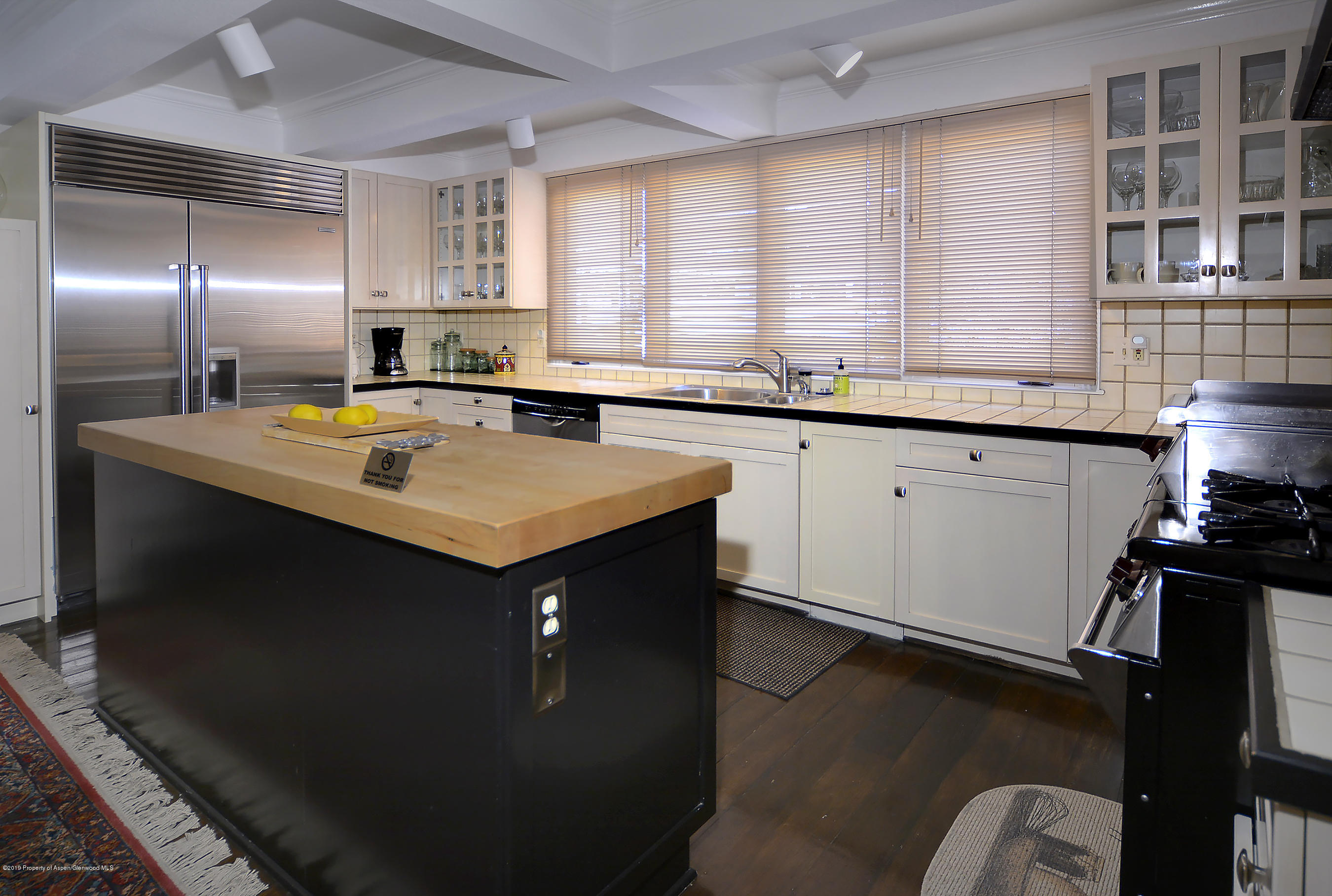 814 East Cooper Avenue Aspen, CO 81611 - Photo 8 of 15 a kitchen that has a sink a stove and a table in it