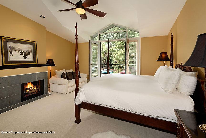 814 East Cooper Avenue Aspen, CO 81611 - Photo 9 of 15 a bedroom with a bed and a fireplace