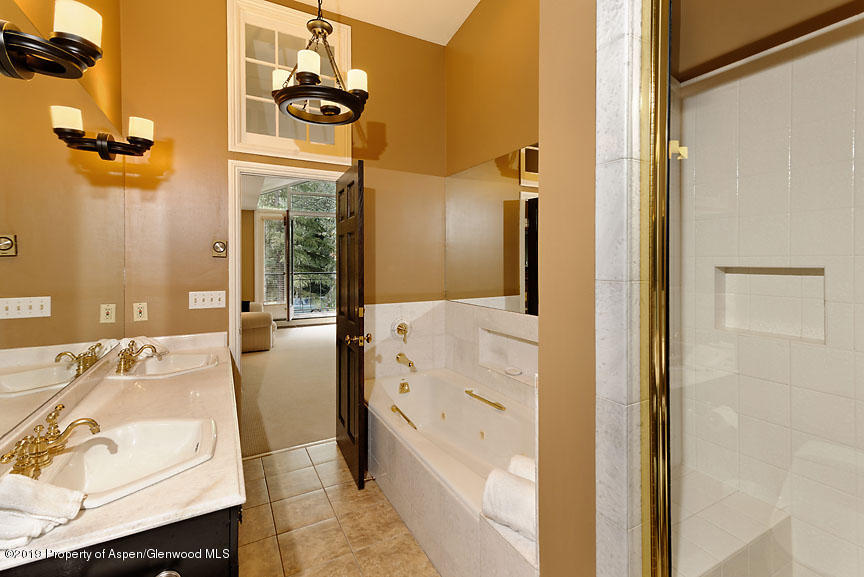 814 East Cooper Avenue Aspen, CO 81611 - Photo 10 of 15 a bathroom with a bathtub sink and mirror