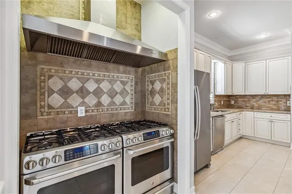 a kitchen with stainless steel appliances granite countertop a stove and a refrigerator