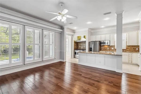 a view of kitchen with stainless steel appliances refrigerator oven and large window