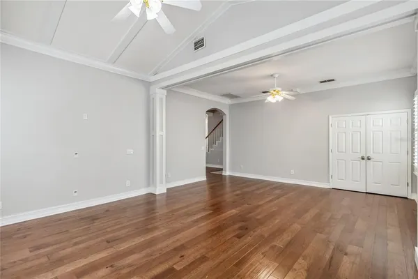 wooden floor in an empty room with a window