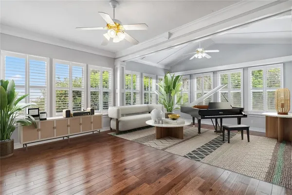 a living room with furniture and large windows