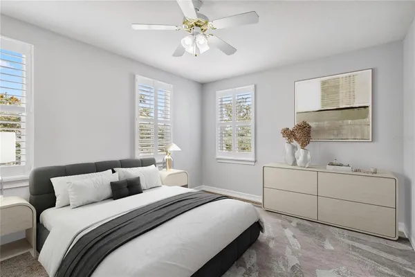 a bedroom with a white bed and a chandelier