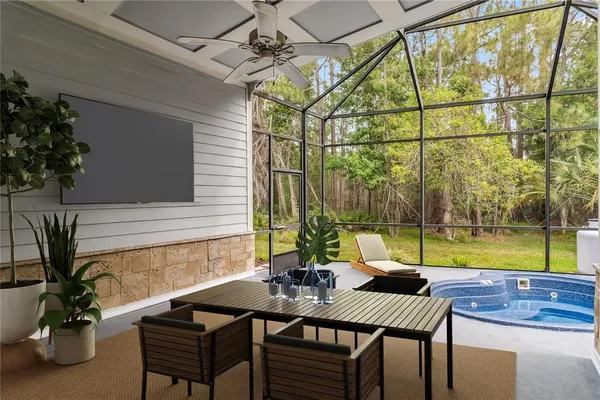 a view of a patio with table and chairs and potted plants