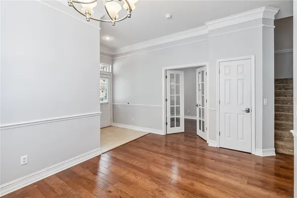 an empty room with wooden floor and cabinet