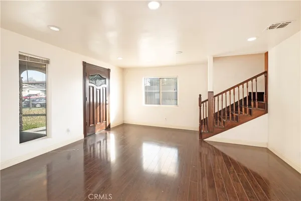 a view of an entryway with wooden floor