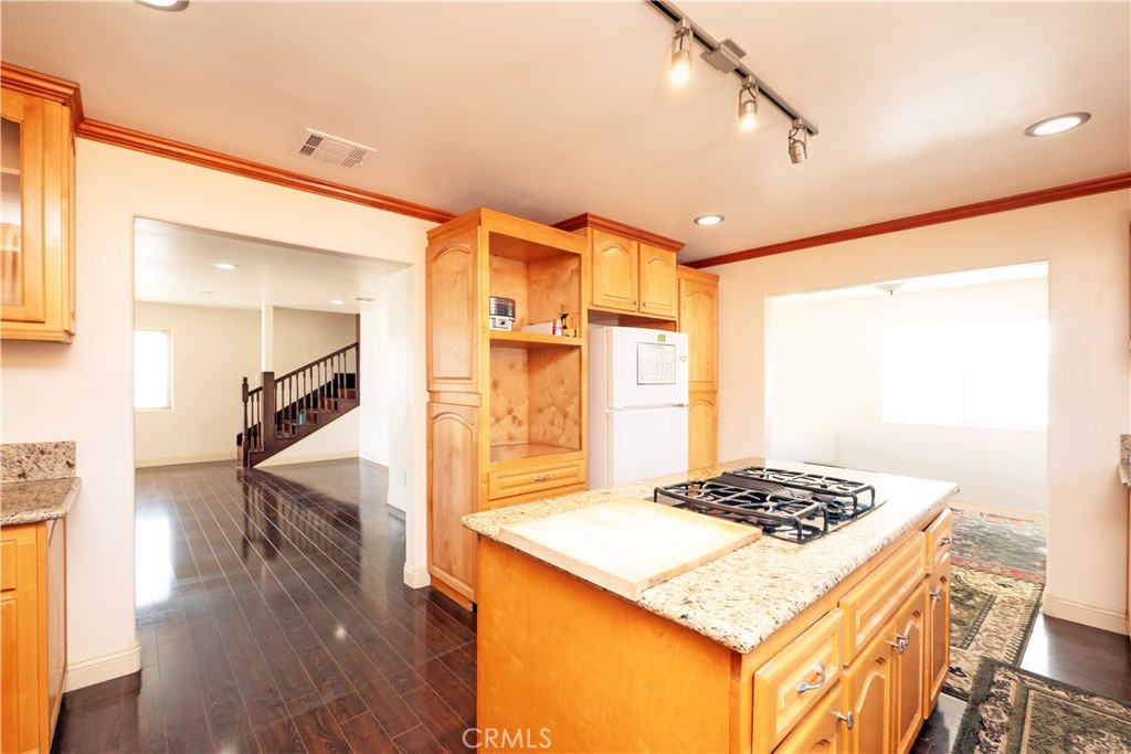 4459 Merced Avenue Baldwin Park, CA 91706 - Photo 15 of 40 a kitchen view of kitchen island a sink stove and wooden floor