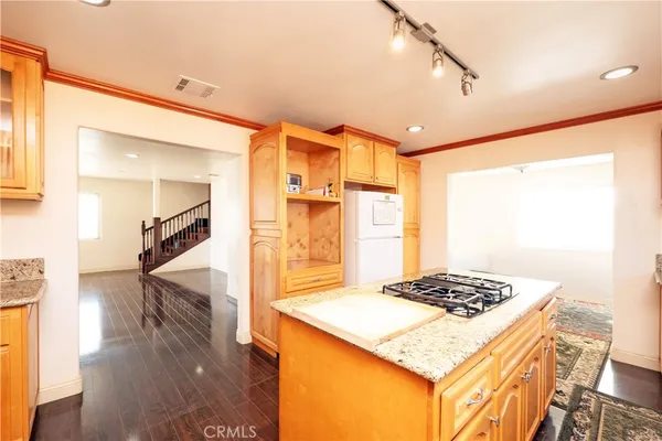 a kitchen view of kitchen island a sink stove and wooden floor