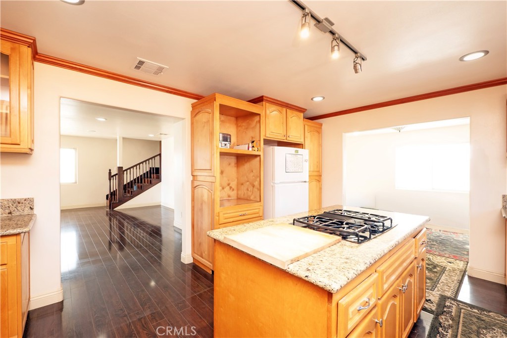 4459 Merced Avenue Baldwin Park, CA 91706 - Photo 16 of 40 a kitchen view of kitchen island a sink stove and wooden floor