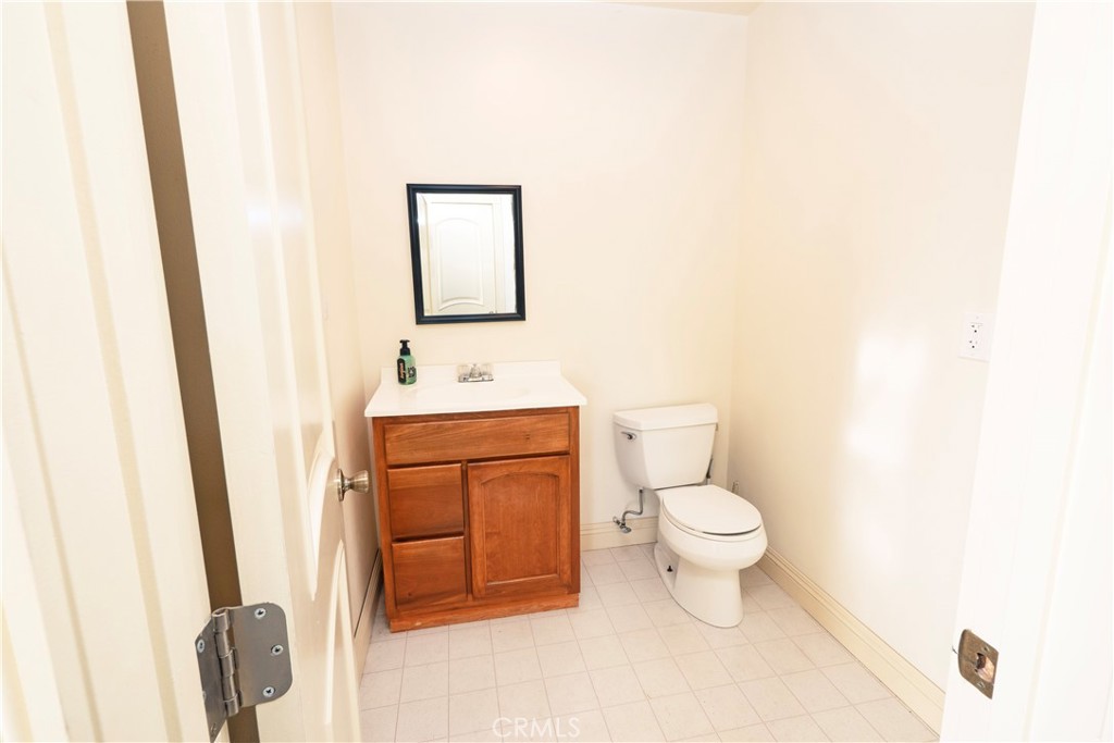 4459 Merced Avenue Baldwin Park, CA 91706 - Photo 16 of 40 a bathroom with a toilet sink and a mirror