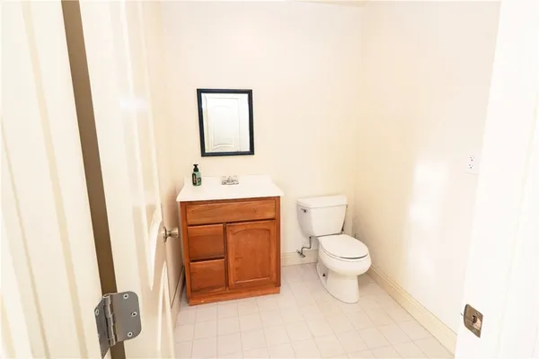 a bathroom with a toilet sink and a mirror