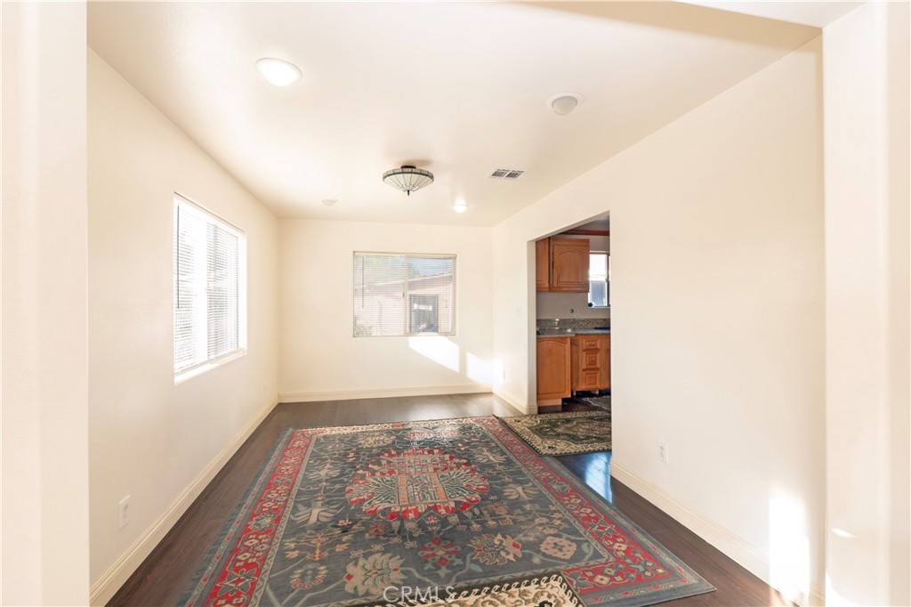 4459 Merced Avenue Baldwin Park, CA 91706 - Photo 17 of 40 a living room with a rug and a window