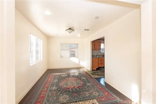 a living room with a rug and a window