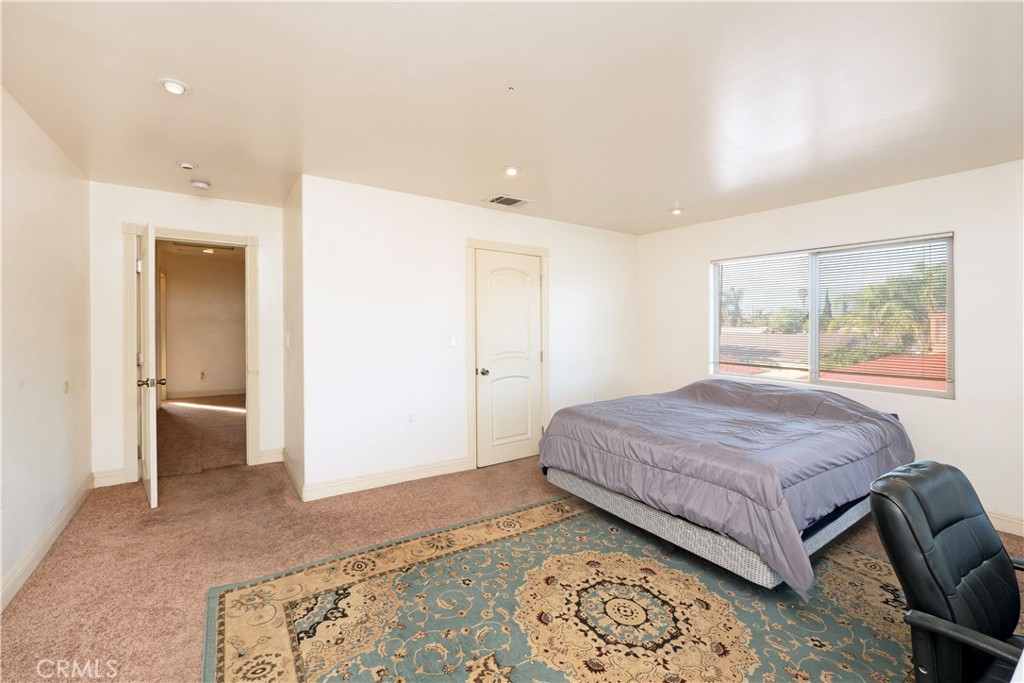 4459 Merced Avenue Baldwin Park, CA 91706 - Photo 20 of 40 a bedroom with a large bed and a couch