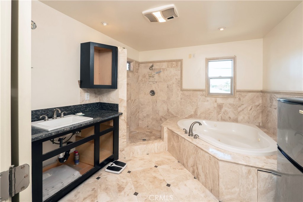 4459 Merced Avenue Baldwin Park, CA 91706 - Photo 21 of 40 a bathroom with a bathtub and a sink