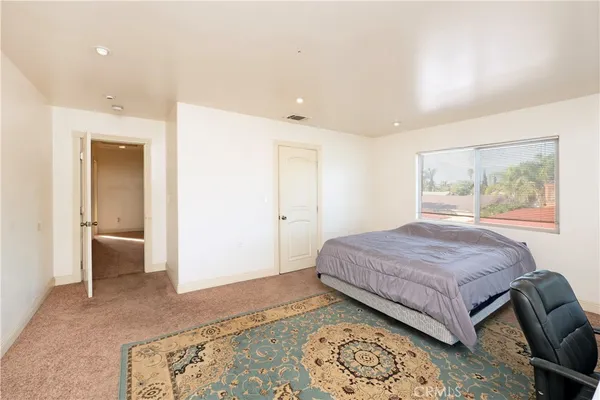 a bedroom with a large bed and a couch
