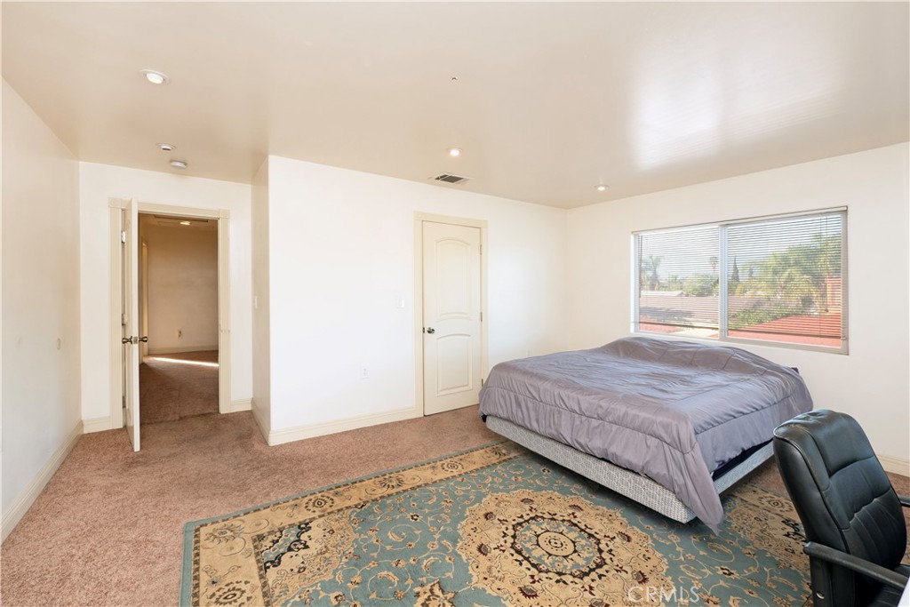 4459 Merced Avenue Baldwin Park, CA 91706 - Photo 21 of 40 a bedroom with a large bed and a couch