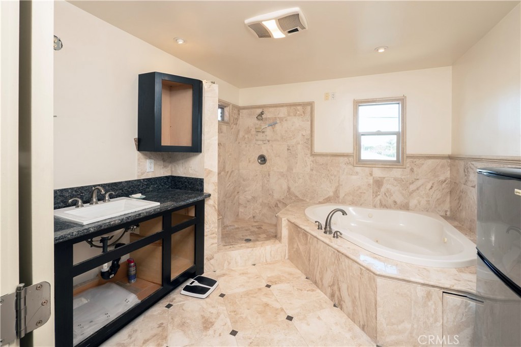 4459 Merced Avenue Baldwin Park, CA 91706 - Photo 22 of 40 a bathroom with a tub a sink and a bathtub