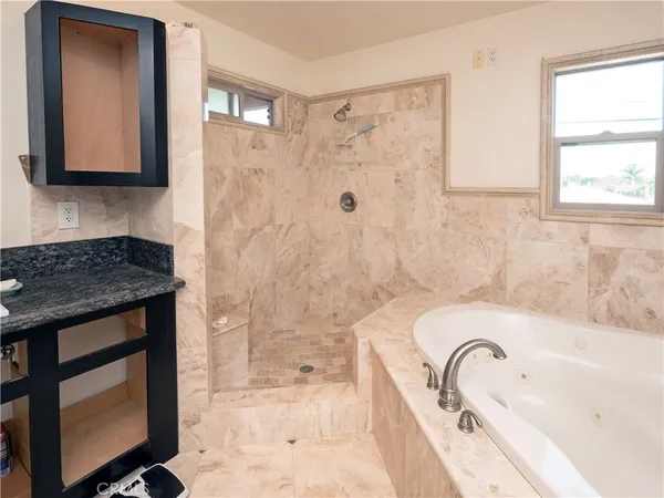 a bathroom with a granite countertop sink a toilet and bathtub