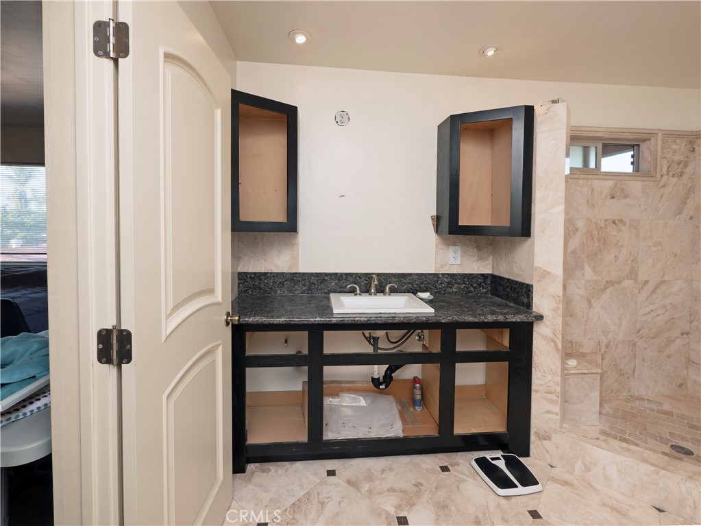 4459 Merced Avenue Baldwin Park, CA 91706 - Photo 25 of 40 a bathroom with a sink and a mirror
