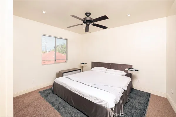 a bedroom with a bed and window
