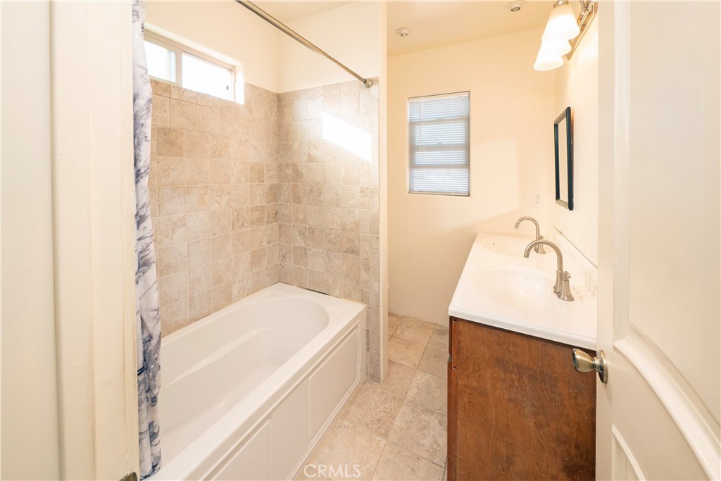 4459 Merced Avenue Baldwin Park, CA 91706 - Photo 27 of 40 a bathroom with a bathtub and shower
