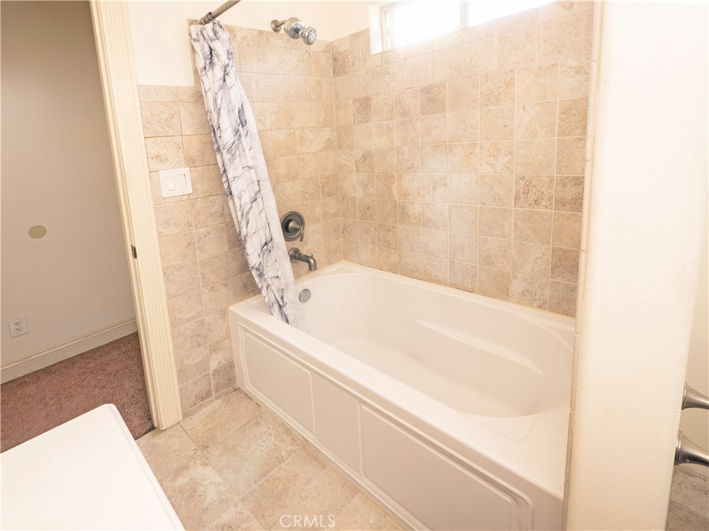 4459 Merced Avenue Baldwin Park, CA 91706 - Photo 29 of 40 a bathroom with a bathtub and shower