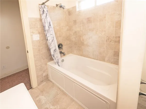 a bathroom with a bathtub and shower