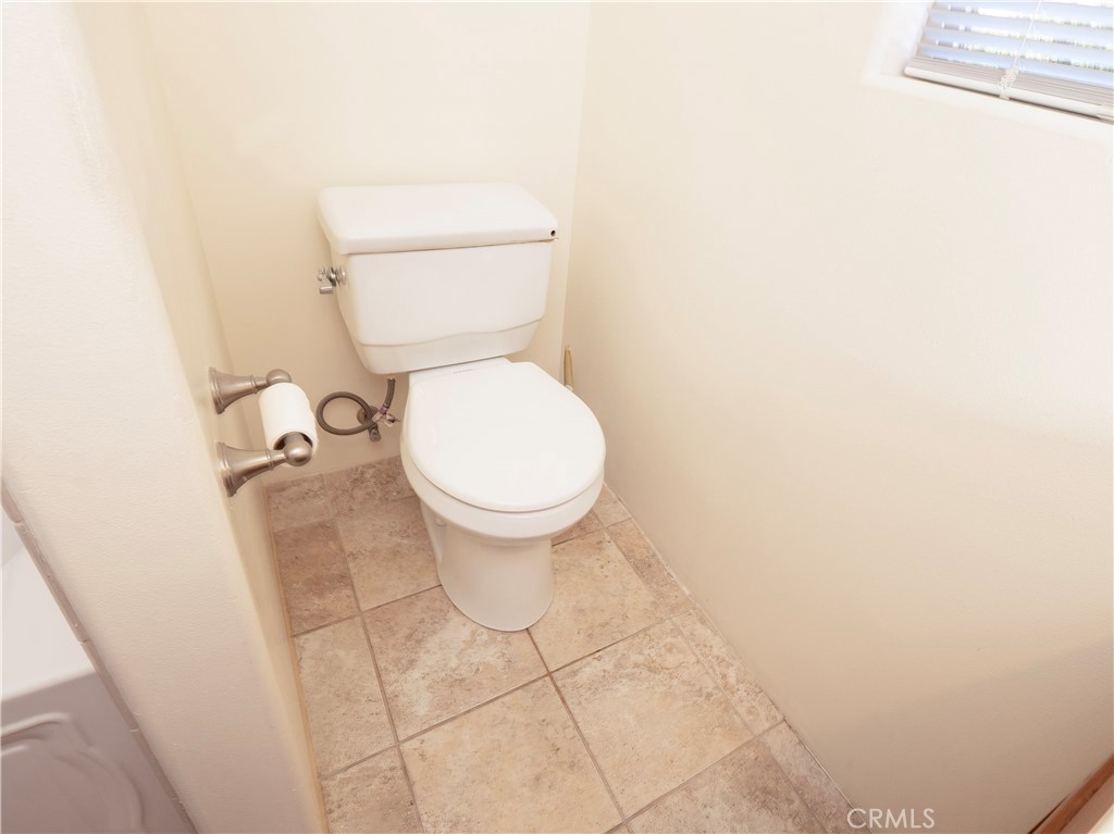 4459 Merced Avenue Baldwin Park, CA 91706 - Photo 30 of 40 a white toilet sitting next to a white wall