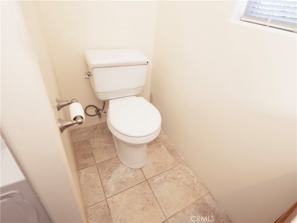 4459 Merced Avenue Baldwin Park, CA 91706 - Photo 31 of 40 a white toilet sitting next to a white wall