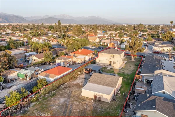 an aerial view of residential houses with city view
