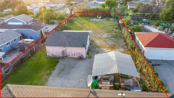 an aerial view of a house with a yard and lake view