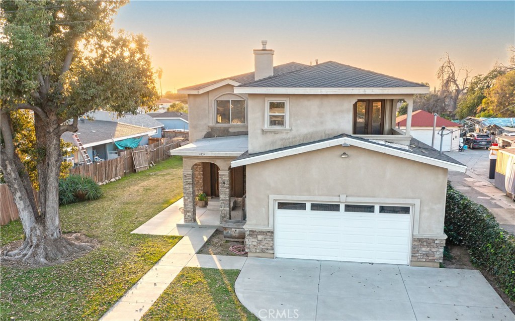 4459 Merced Avenue Baldwin Park, CA 91706 - Photo 7 of 40 a front view of a house with a yard and garage